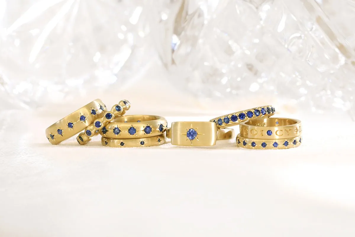 20K Gold Narrow Slightly Rounded Ring with 10 Star-Set Blue Sapphires